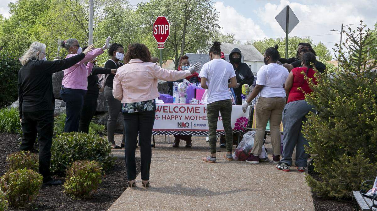A prayer is made for the three women at right after they were released from the St. Clair County Jail. Members of United Congregations of Metro East (UCM), and National Bail Out Collective (NBO) worked together to unite three mothers with their families for Mother’s Day. The three mothers were in the St. Clair County Jail and could not afford to pay their bond. The groups paid the bond to get the three released in time for Mother’s Day.