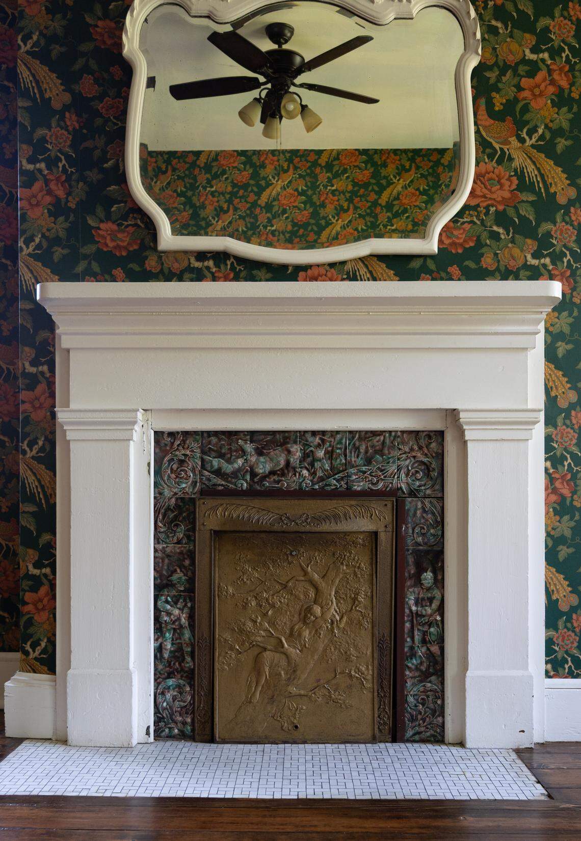 Each fireplace in the home comes with its own intricately carved fireplace cover. This room on the second floor is surrounded by custom floral wallpaper that looks straight out of a 19th century baroque catalogue.