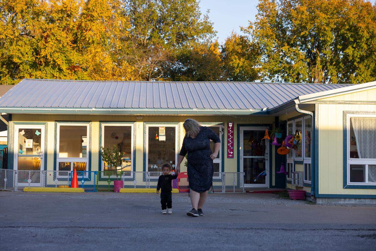 Heather Casner walks Royce Lingle to his mother’s car.