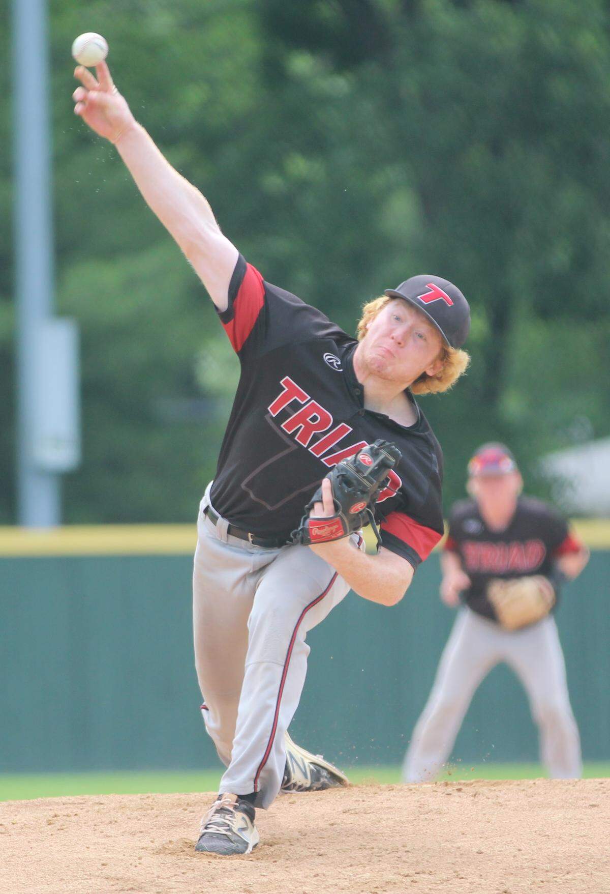 Triad senior Mack Langdon unloads a pitch against Columbia in the Class 3A Centralia Sectional championship game Saturday.