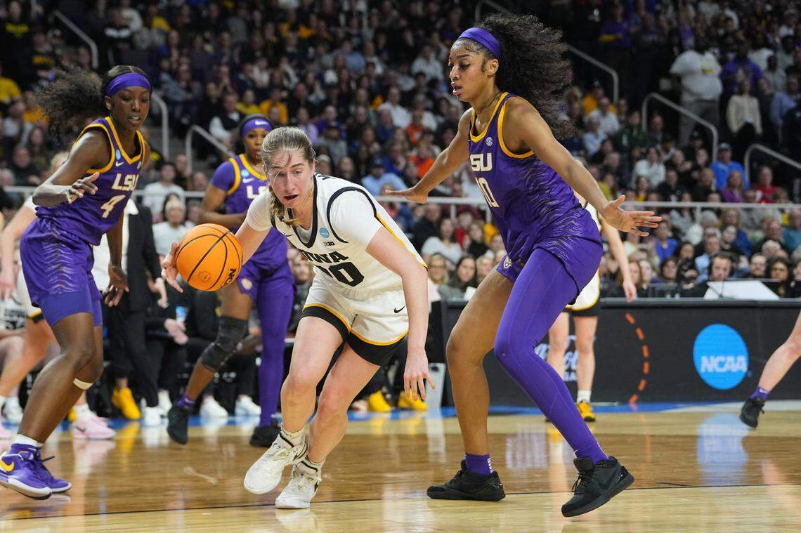 Apr 1, 2024; Albany, NY, USA; Iowa Hawkeyes guard Kate Martin (20) controls the ball against LSU Lady Tigers forward Angel Reese (10) in the second quarter in the finals of the Albany Regional in the 2024 NCAA Tournament at MVP Arena. Mandatory Credit: Gregory Fisher-USA TODAY Sports