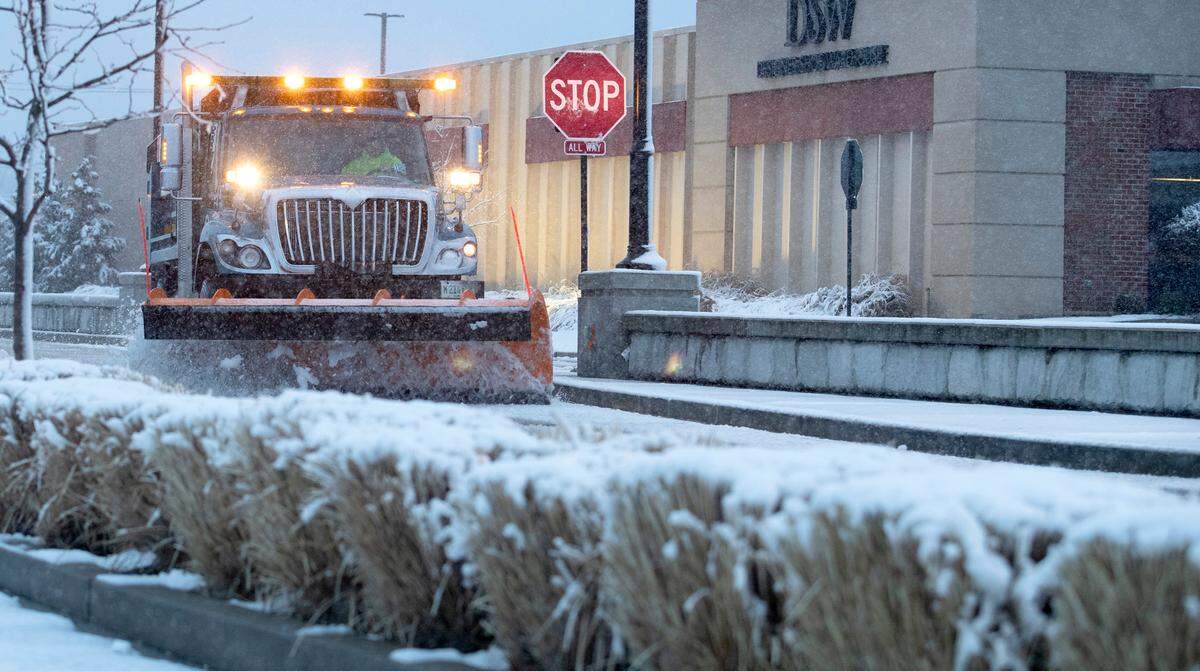 A Fairview Heights snow plow clears the wet, slushy snow from Market Place Wednesday morning. According to a National Weather Service of St. Louis representative, the region has seen 1-3 inches of accumulating snow. As of early Wednesday morning, they did not expect that total to increase much, if at all.