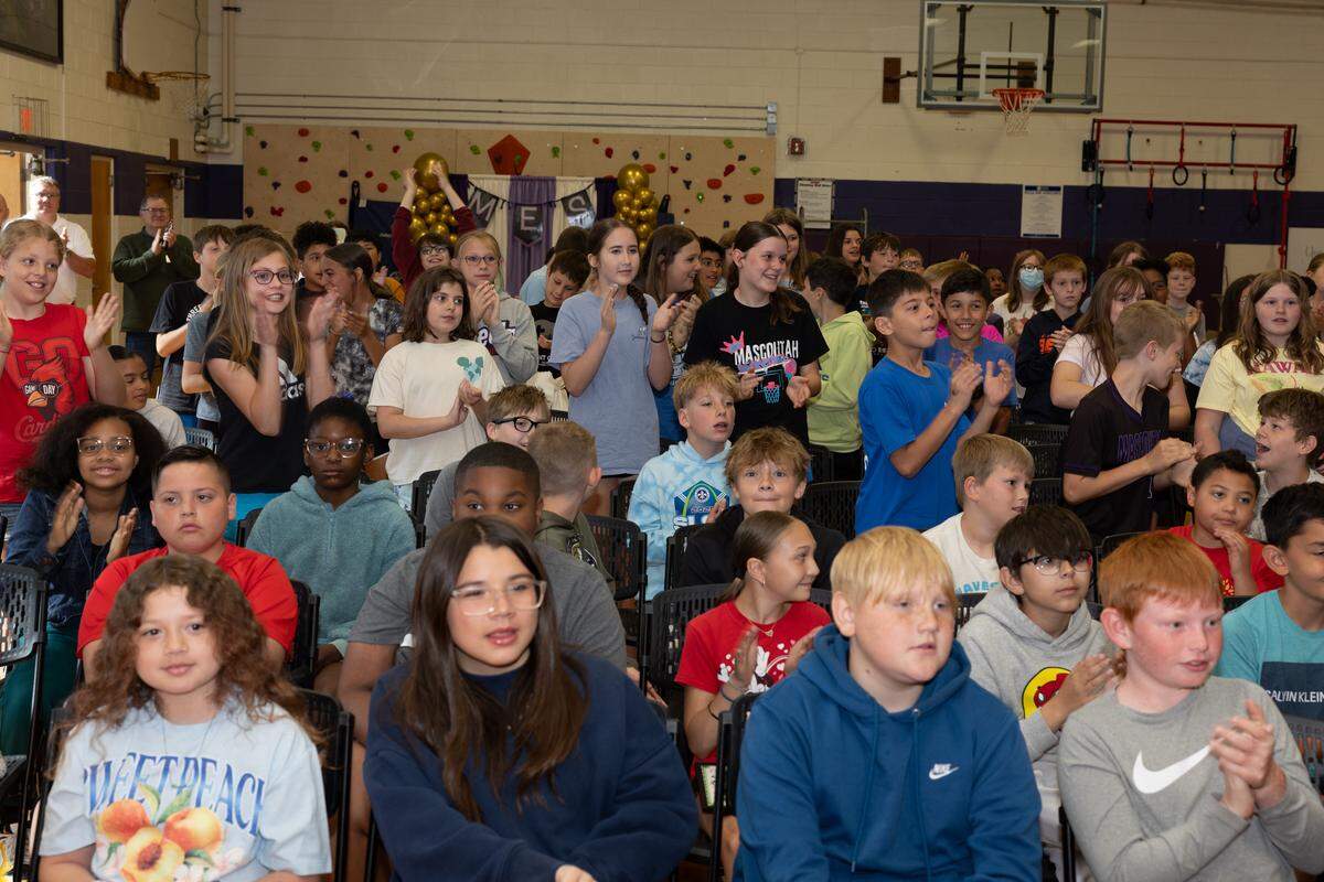 Children attending Mascoutah Elementary clap for fifth-grade teacher Joshua Veath, who won a 2026 Golden Apple award.