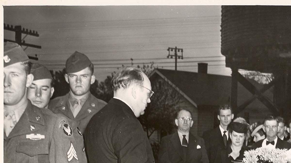 The parents of Capt. William "Bill" Mueller, Barbara and Ernest Mueller, stand behind the coffin of their son after it arrived in October 1947 in Belleville. Bill Mueller was killed Oct. 22, 1944.