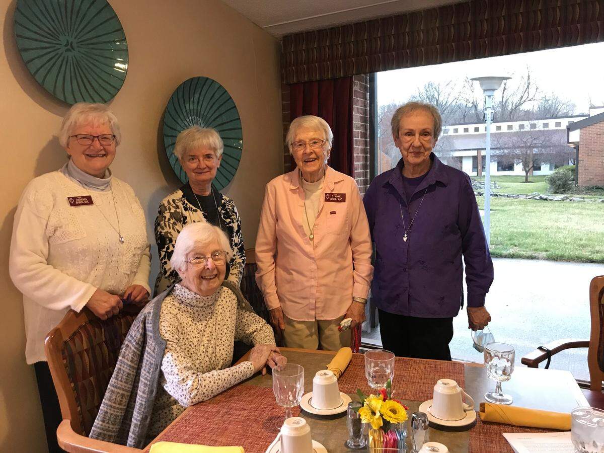Sister Gabrielle Rowe, seated, Sister Anne Irose and Sister Mildred Gross, right, are shown in the dining hall of their new home at the Benedictine Living Community in Belleville. At left is Sister Barbara Biver, who is helping them get settled, and Sister Mary Catherine Clark, a leader with the U.S. Region of the Adorers of the Blood of Christ.