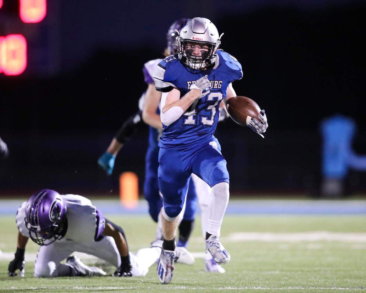 Freeburg’s Tucker Murphy (43) carries the ball for a first down against Breese Central in the Cahokia Conference opener for both teams Friday night. The Midgets ultimately fell to the Cougars 31-19.