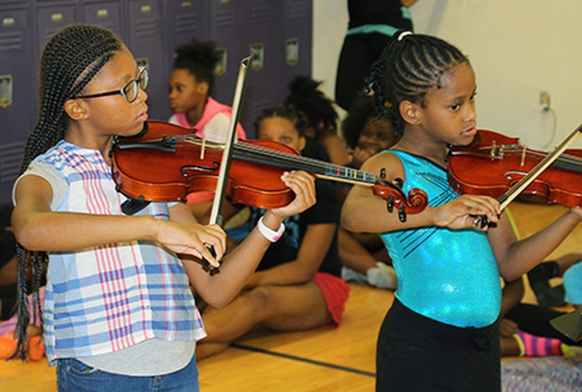 SIUE East St. Louis Center for the Performing Arts students rehearse for their July 27 concert at East St. Louis Senior High School.