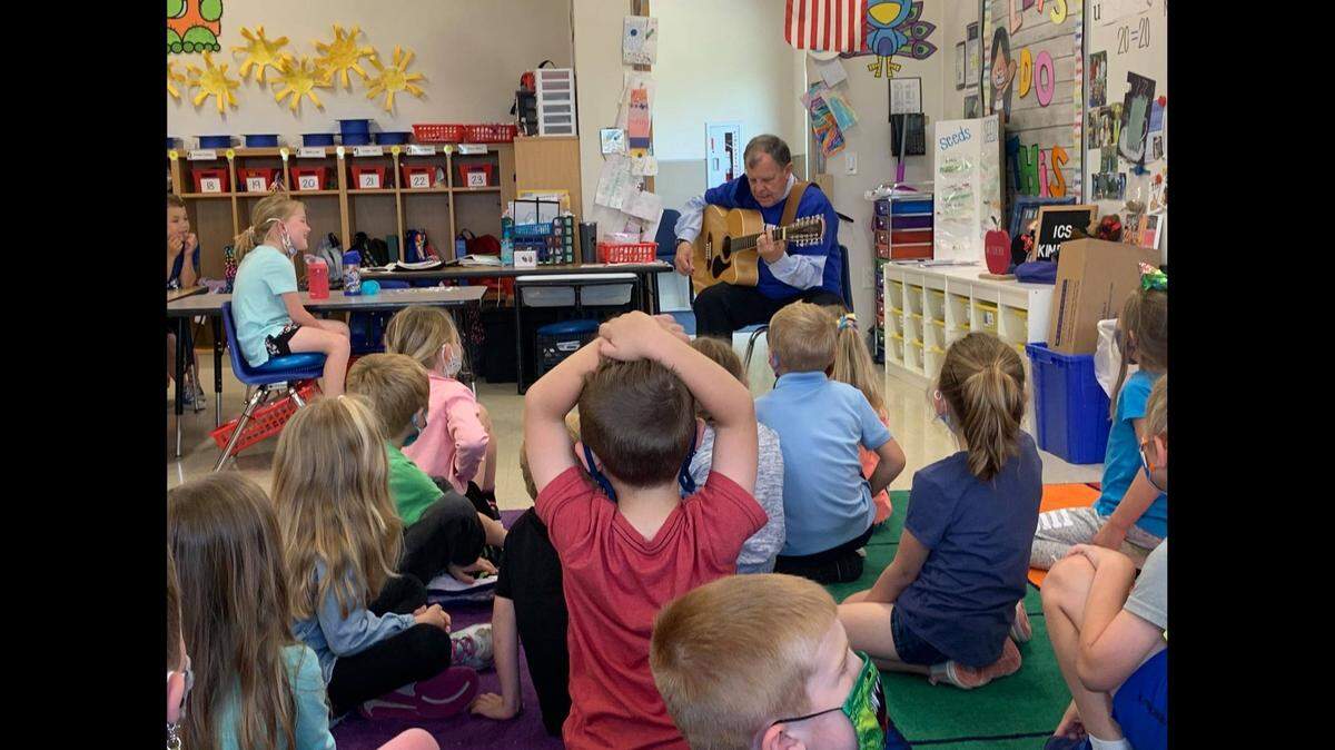 Principal Michael Kish sings and plays guitar for a kindergarten class at Immaculate Conception Catholic School in Columbia earlier this week.