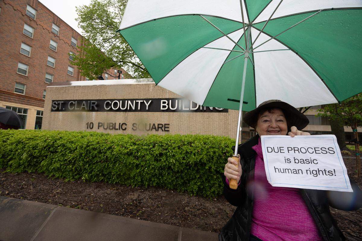 Shirley Gasparich holds up a sign saying “DUE PROCESS is basic human rights!” outside the St. Clair County Building during a protest on Saturday. Gasparich, 81, says Saturday’s protest was her first. “It’s just appalling, everything they’re doing,” Gasparich said. “We have to get out there and let them know it’s not OK to just rip people off the streets.”