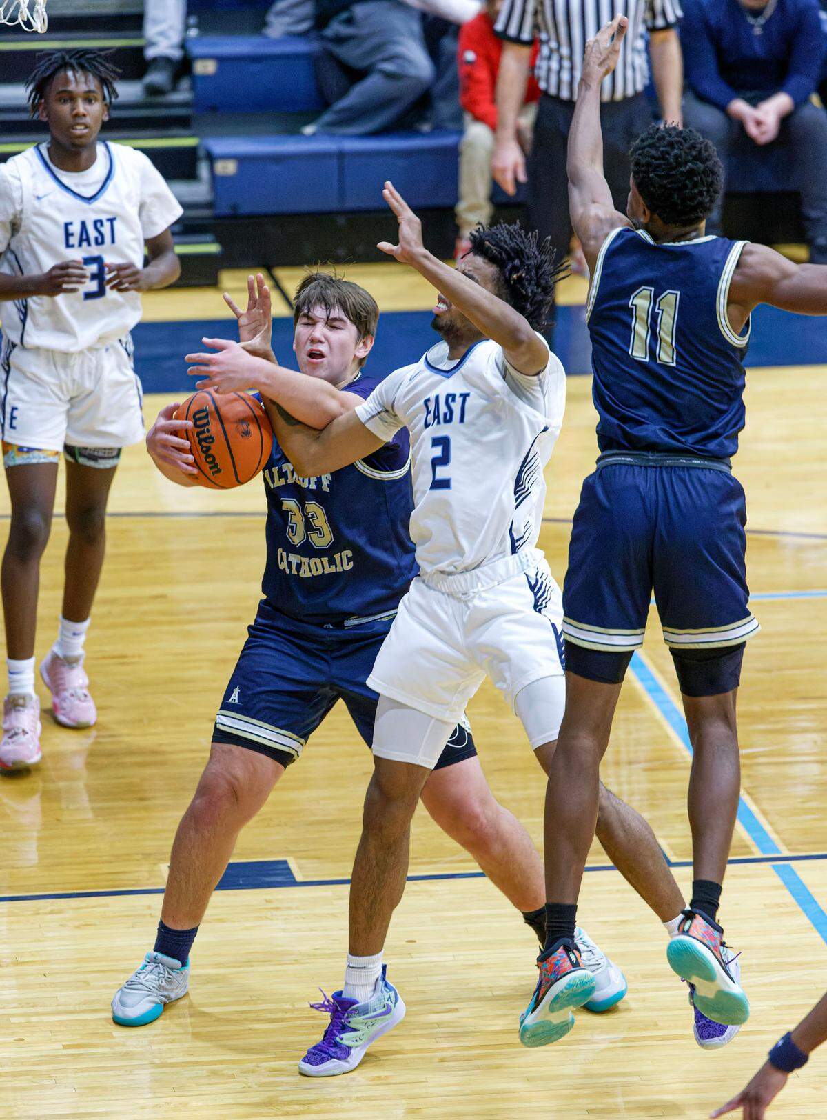 Althoff’s Patton Leib battles Belleville East’s Antwine Wilson for the ball during Tuesday’s non-conference match-up. The Lancers ultimately posted a 78-50 victory.