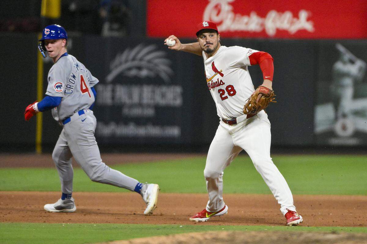 Jun 24, 2025; St. Louis, Missouri, USA;  St. Louis Cardinals third baseman Nolan Arenado (28) barehands a ground ball and throws out Chicago Cubs shortstop Dansby Swanson (not pictured) during the ninth inning at Busch Stadium. Mandatory Credit: Jeff Curry-Imagn Images