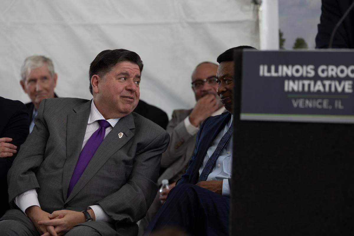 Illinois Gov. J.B. Pritzker shares a joke with Ed Hightower before a news conference in Venice, Ill. on Nov. 5, 2025.