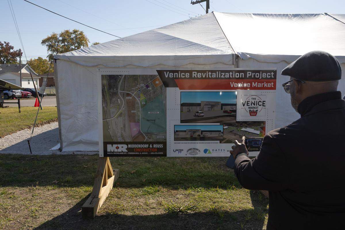 Dwayne Mays, cousin to developer Ed Hightower, takes a photo of future plans regarding a grocery store in the city of Venice, Ill.