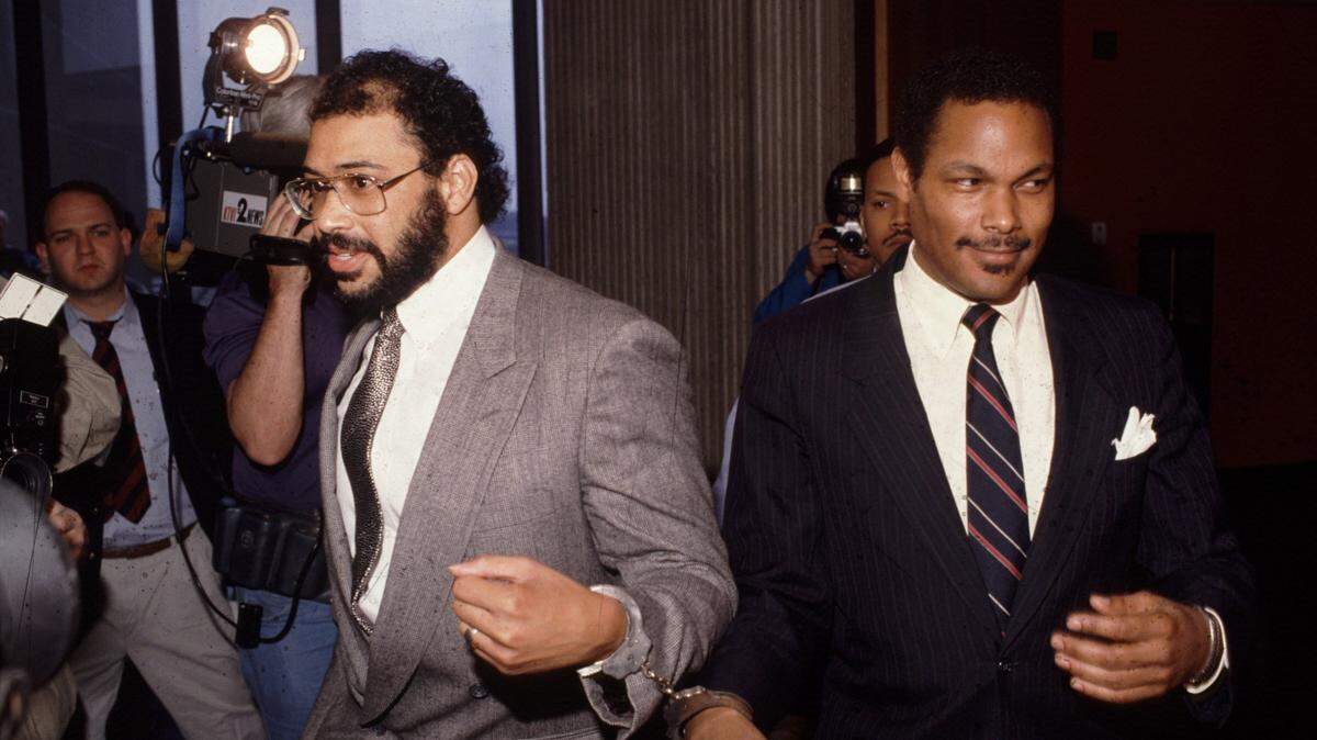 Handcuffed together, attorney Eric Vickers and East St. Louis Mayor Carl Officer on April 14, 1989, leave the courtroom of St. Clair County Associate Judge Sheila O'Brien. O'Brien found them in contempt for missing a hearing on the city's progress fixing sewers that were allowing raw sewage to flood a school and homes.