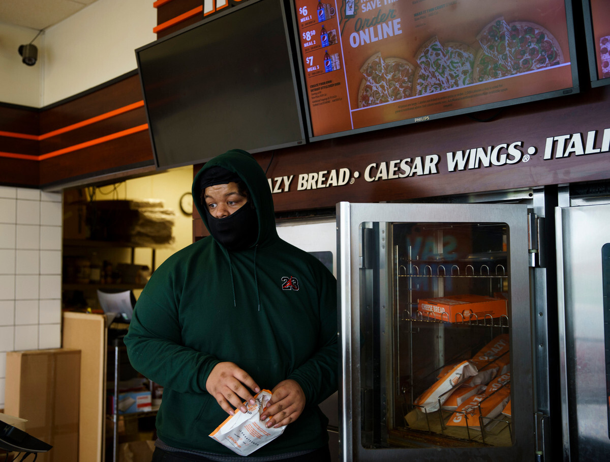 Christian is using part of his paychecks from a job at Little Caesars to pay off a ticket he received at school.