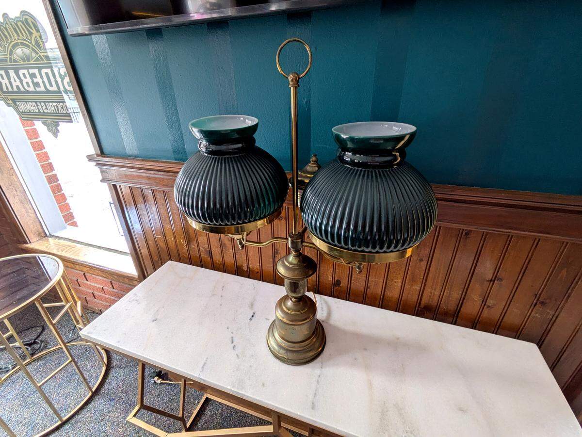 The décor and lighting at Rachel’s Sidebar feature a lot of brass and green glass to provide an art deco feel.