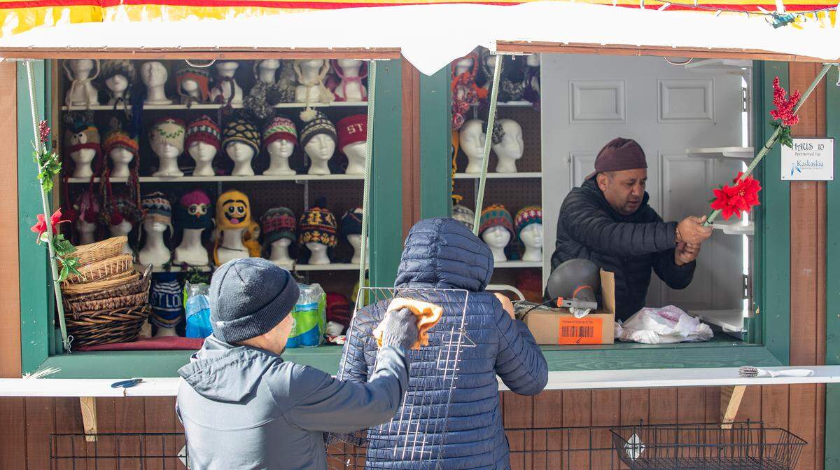 Workers stocked, cleaned and prepared the Whimzy Collection booth for opening day of the Belleville Christkindlmarkt on Friday, Nov. 25 on the Public Square. The Whimzy Collection features colorful, handcrafted wool and felt products from Nepal. The open-air German style holiday market features a variety of vendors including, woodworking, photography, ornaments, German bakery, Polish pottery, and much more. For a complete schedule and vendor list visit www.bellevillechristkindlmarkt.com.