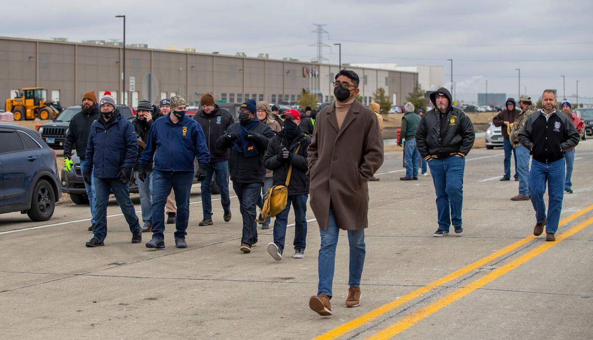 Union workers gather at a rally at the Amazon warehouse in Edwardsville, where six people died in a tornado on Dec. 10.