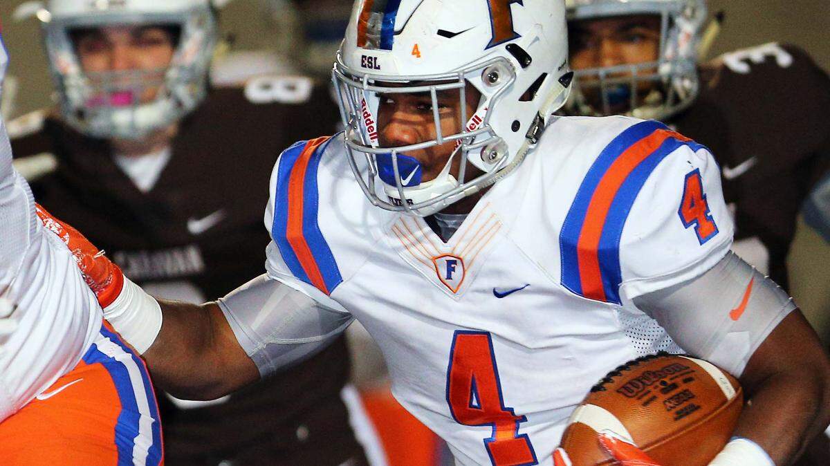The Flyers’ DeMonta Witherspoon carries the ball during the IHSA 7A, Quarterfinal game at Mount Carmel Saturday.