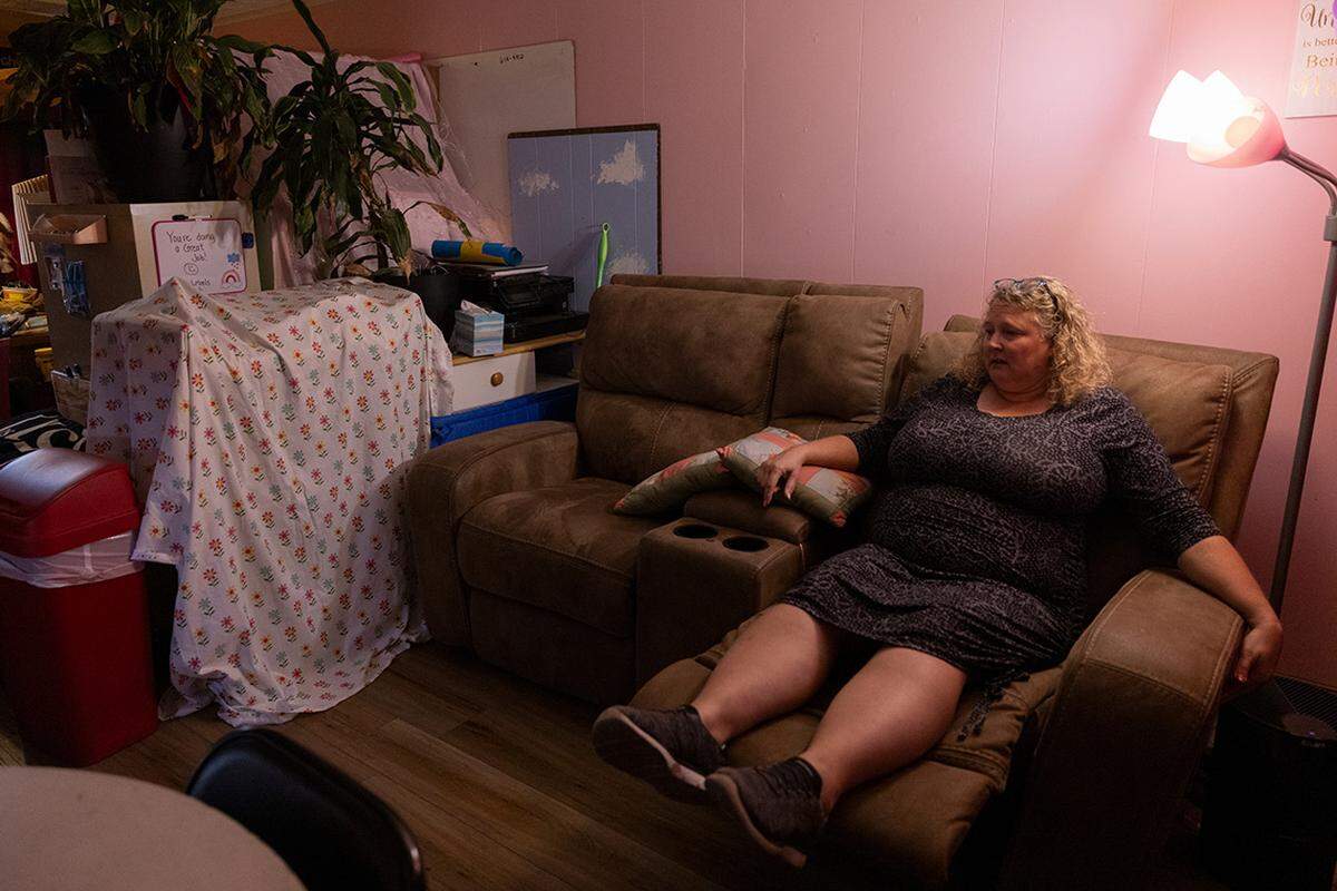 Heather rests in the break room at the end of the day.