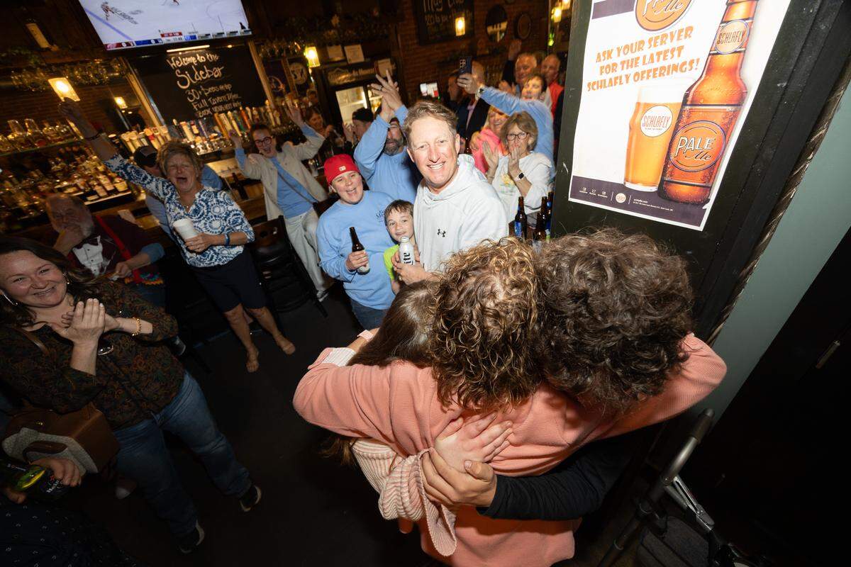 Jenny Gain Meyer hugs supporters after arriving at a watch party for the April 1 election, where she was leading the race for Belleville mayor against Patty Gregory.