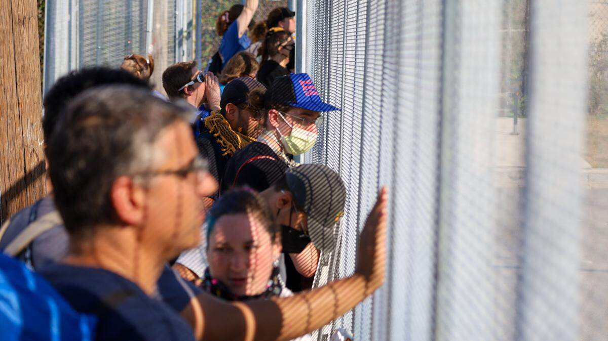 A few dozen protestors and reporters gathered outside an immigration enforcement facility in Broadview on Saturday, Oct. 4. The facility has become a focal point of protest since ICE officials expanded their immigration enforcement in Chicagoland.