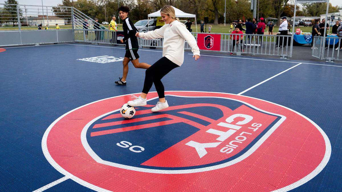 Ava Digirolamo, 16, of Collinsville, plays soccer with Mike Suarez, 15, of Fairmont City, on Thursday, Oct. 26, 2023, before the dedication of a St. Louis City SC mini pitch at Granby Park in Fairmont City.