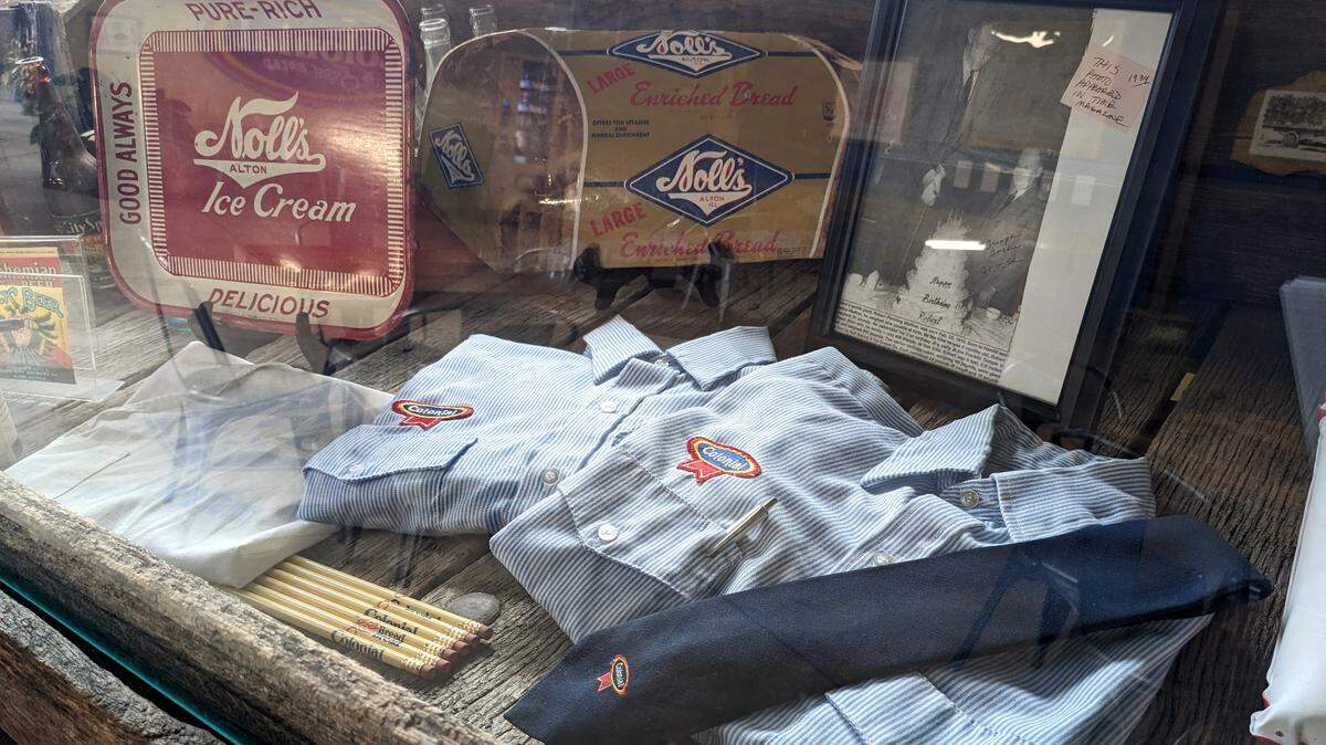 A display case at Old Bakery Beer contains memorabilia from historic Alton businesses, including Colonial Bread, which once operated out of the 19th-century building.