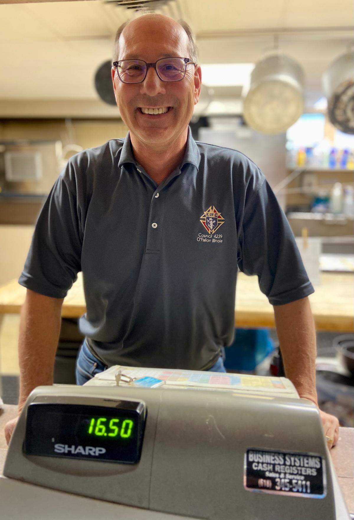 Volunteers and staff at the O’Fallon Knights of Columbus Hall are gearing up for the biggest fish fry in town this Lenten season, and have extended Friday dinner service to 8 p.m. Pictured, Duane Daniels cheerfully takes orders at the kitchen window.