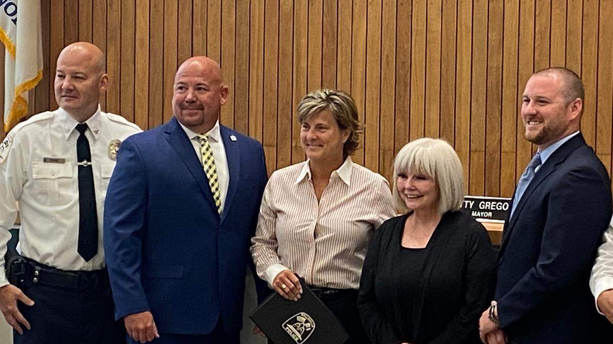 Belleville Police Chief Matt Eiskant, left, poses with police officers Shane Brown, Kim Fulkerson, Mayor Patty Gregory and officer Aaron Spargur after the City Council voted to approve promotions for the officers Monday night.