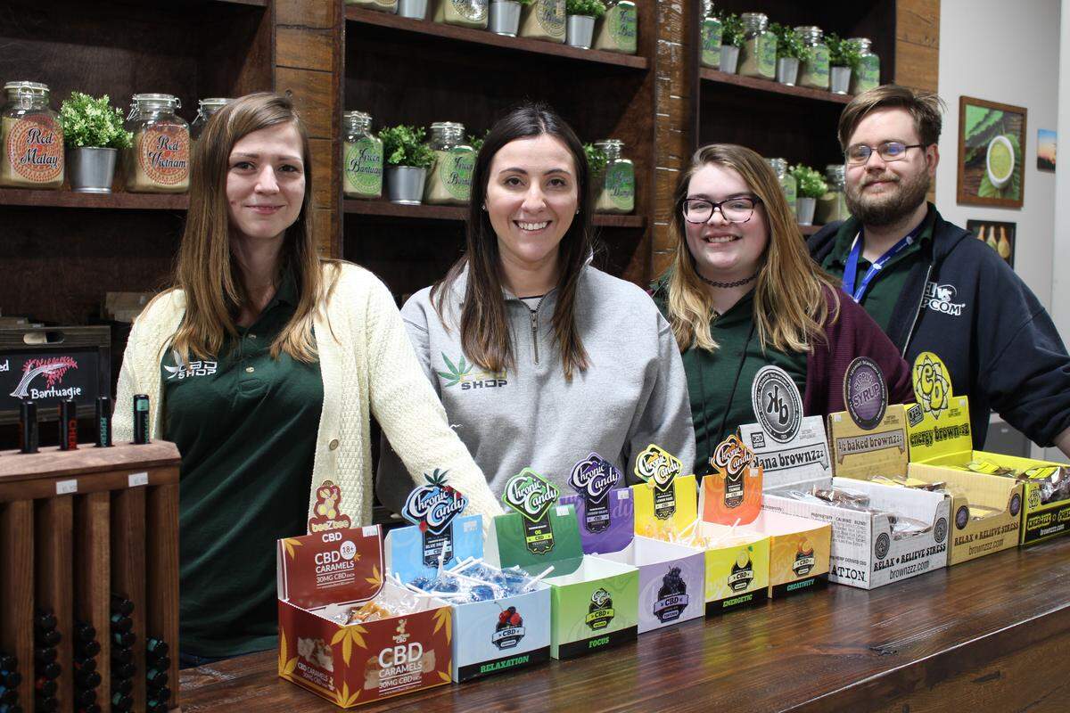 Brea Emery, left, manager of the new CBD Kratom store in Belleville, poses with co-owner Dafna Revah and employees Anna Scott and Marty Schulz.