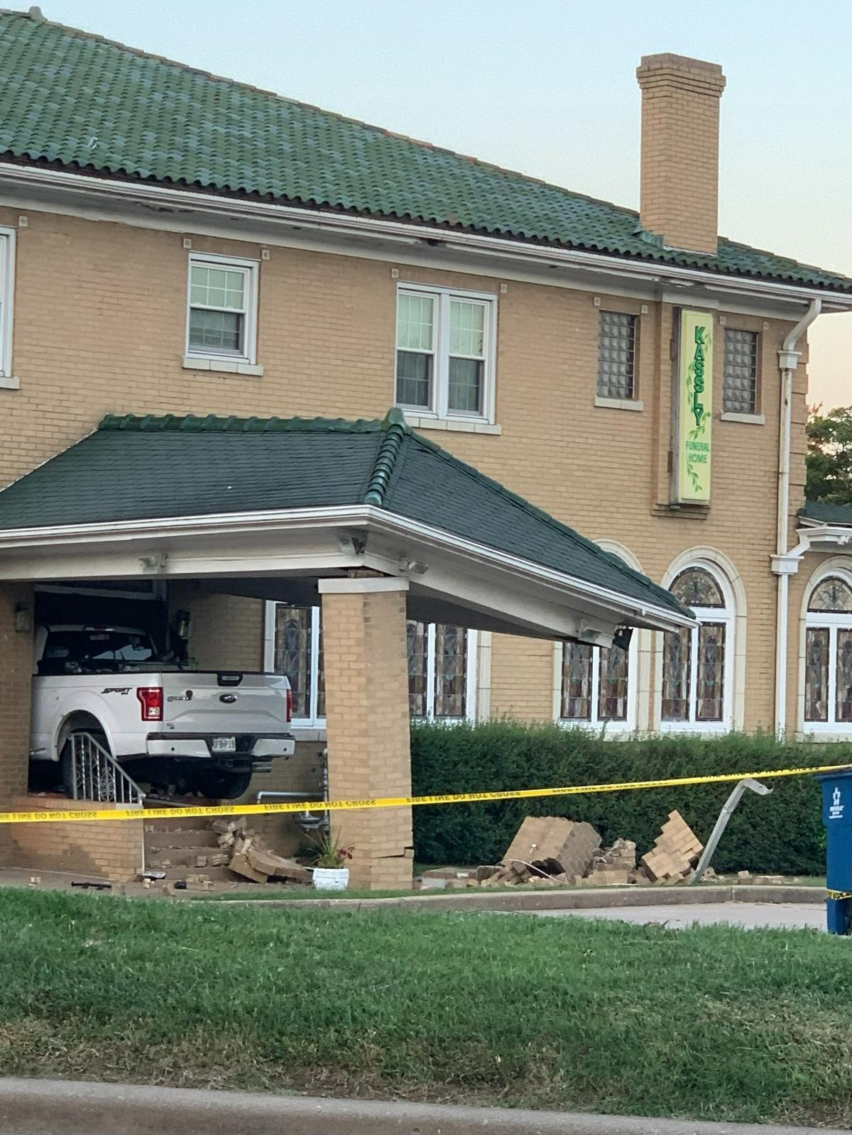 A white Ford truck that crashed into Kassly-Meridith Funeral Home in Collinsville early Sunday was still lodged in the building on Monday.