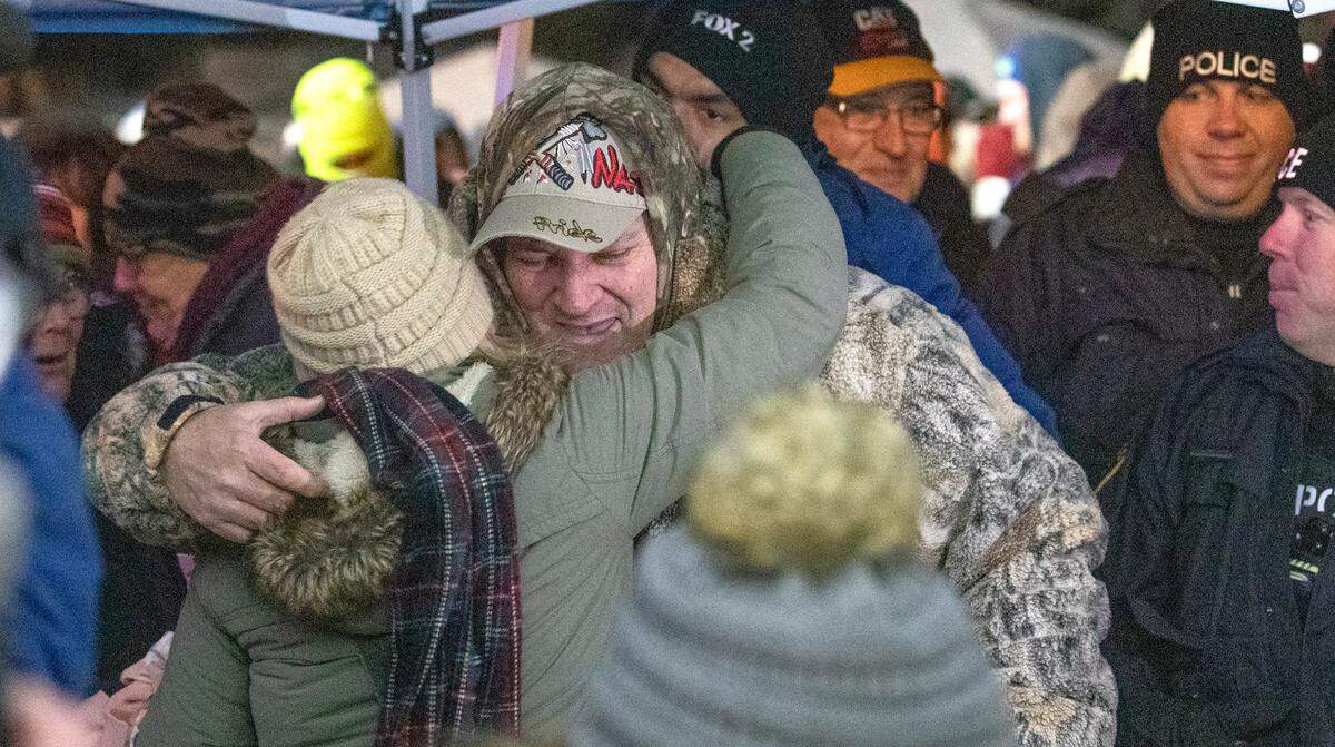 Sam Houston , 61, of Red Bud gets a congratulatory hug after picking the Queen of Hearts and winning nearly $1.9 million in the Saints Peter and Paul Catholic School raffle in Waterloo Tuesday night.
