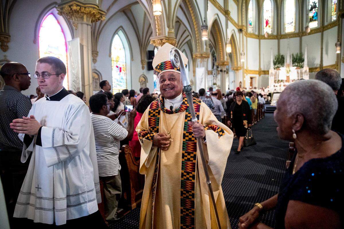The Most Rev. Wilton D. Gregory, center, leaves St. Augustine Catholic Church on June 2, 2019, less than two weeks after he was installed as archbishop of Washington.