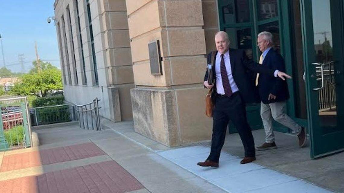 Retired contractor Gregg Crawford, right, walks out of U.S. District Court for the Southern District of Illinois in East St. Louis with his attorney, David Niemeier, after being sentenced for bank fraud on Thursday.