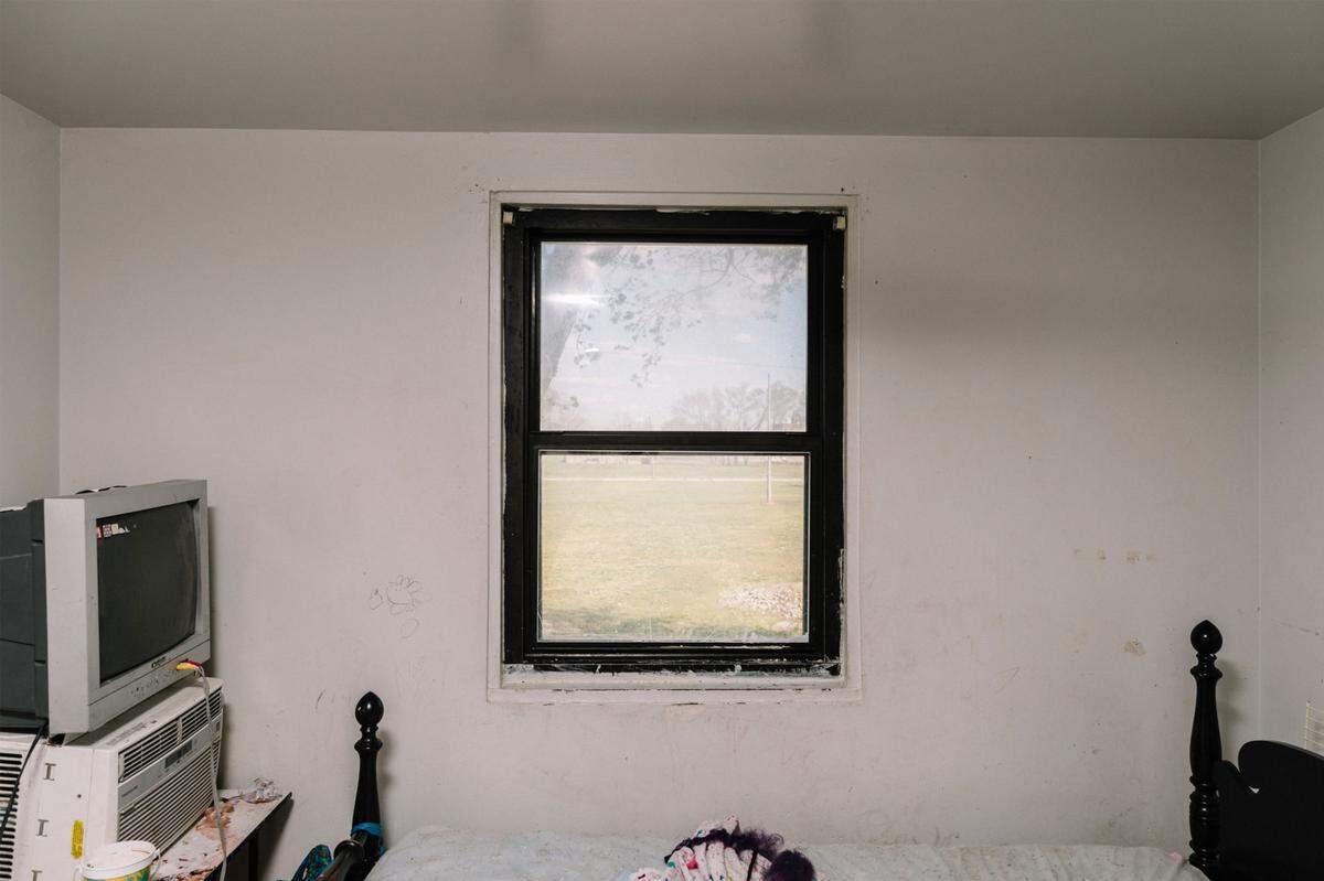 A broken window inside the bedroom of an apartment at the Samuel Gompers Homes, part of the East St. Louis Housing Authority.