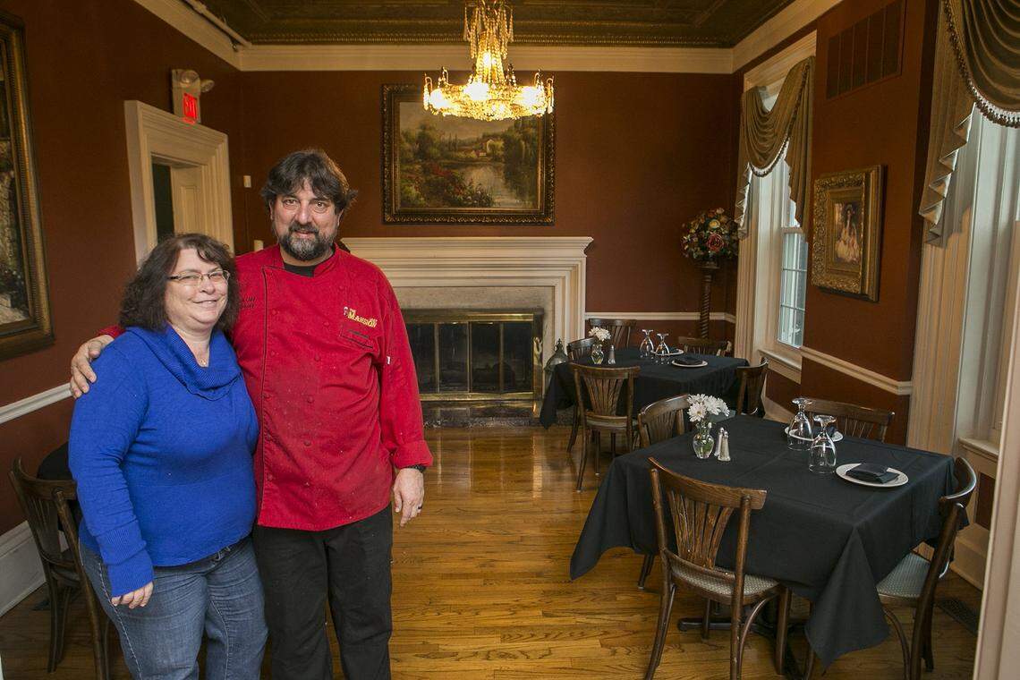 The Grille at the Mansion owners Kathy Cox and Jerry Conway are shown in one of its dining rooms in 2017, before they closed the restaurant and limited their services to weddings and other private events.