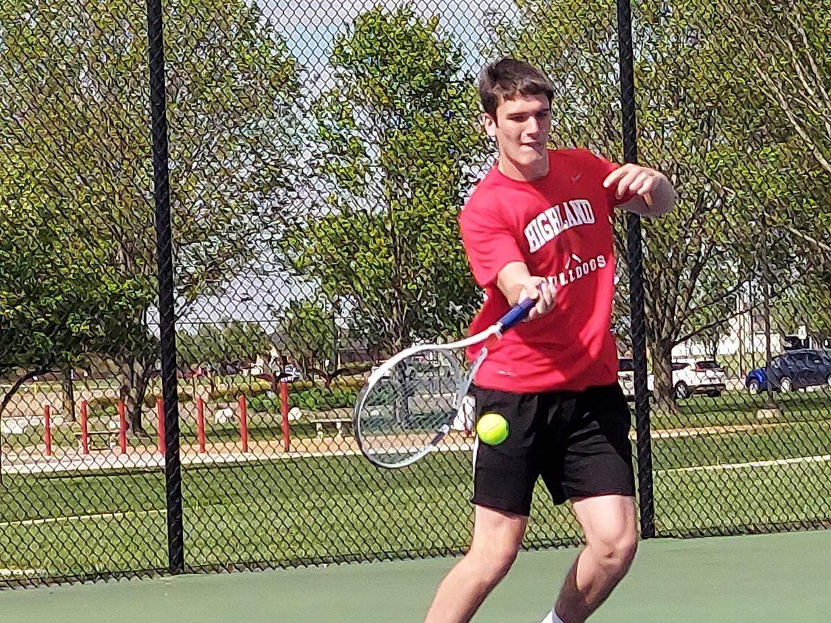 Highland’s Grant Fleming returns a shot in his No. 1 singles match against Triad’s Jake Stewart during Mississippi Valley Conference action Monday, May 1, 2023, at Highland High School. The Knights went on to defeat the Bulldogs.