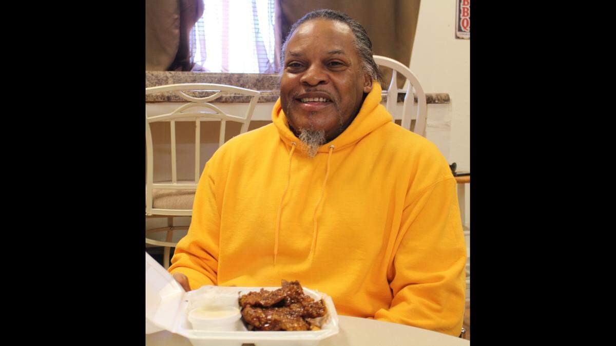 Customer Melvin Jones is all smiles getting ready to eat an order of snoots at Good Heavens BBQ & Bakery in East St. Louis.