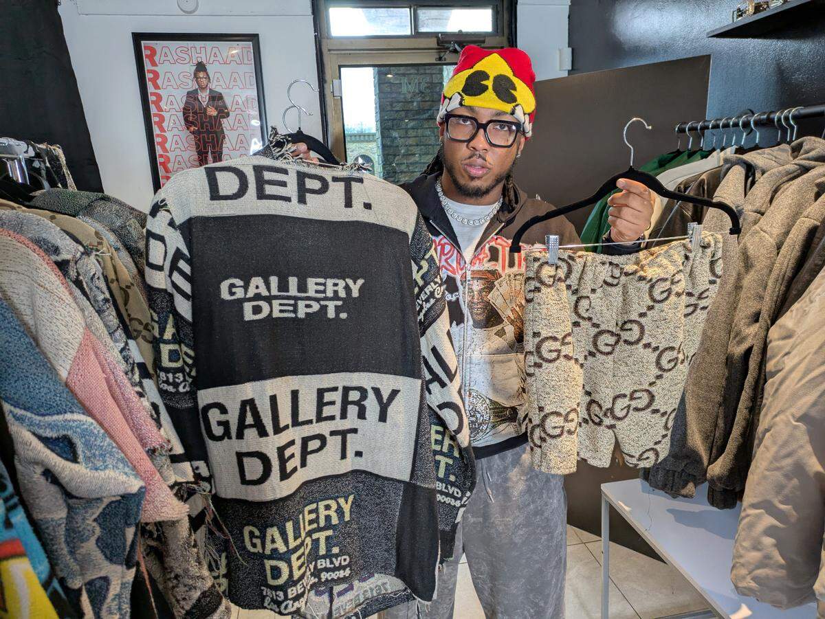 Luster shows off a jacket and shorts he made from woven tapestry blankets.