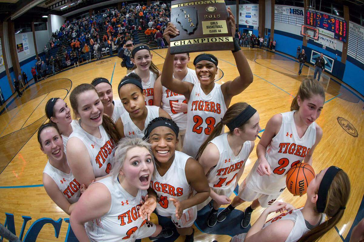 The Edwardsville Tigers celebrate their Class 4A Regional Championship game with a 41-40 victory over the Belleville East Lancers.