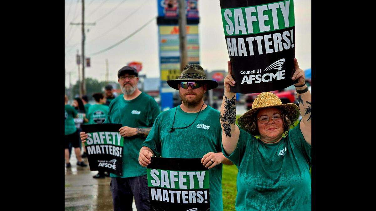 From right to left, Falynne Muzzy, a correctional lieutenant, and Hursel King, a correctional sergeant, both employed at Menard Correctional Center, and Michael Knope, a correctional sergeant at Pinckneyville Correctional Center, joined hundreds of other prison workers and their supporters in Chester on Monday to rally against unsafe working conditions. (Capitol News Illinois photo by Molly Parker)