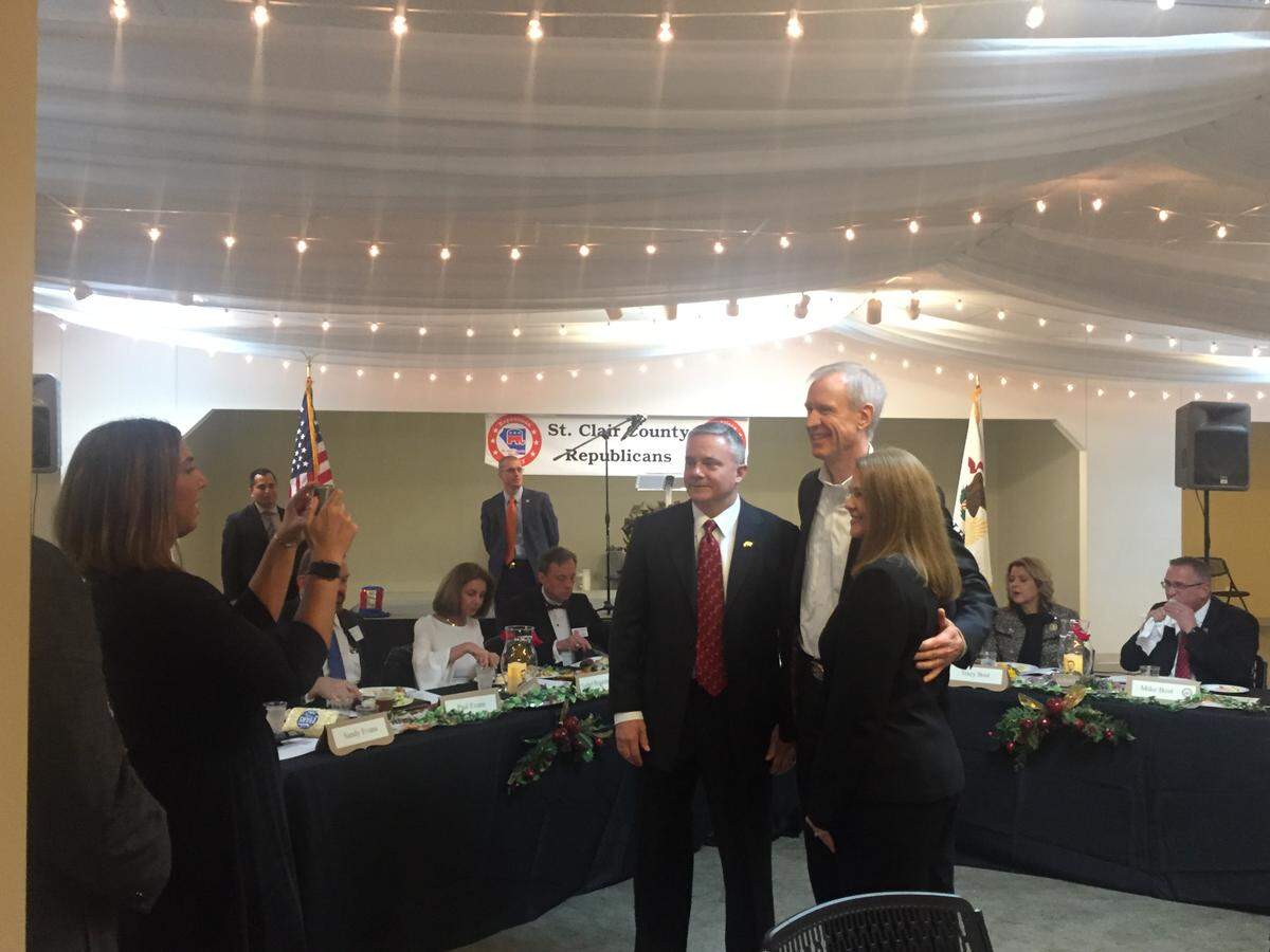 Gov. Bruce Rauner poses for a photo at the Gateway Classic Cars showroom in O'Fallon, where GOP insiders gathered Saturday evening for a gala. Rauner's challenger in the Republican gubernatorial primary, state Rep. Jeanne Ives, was also in attendance.
