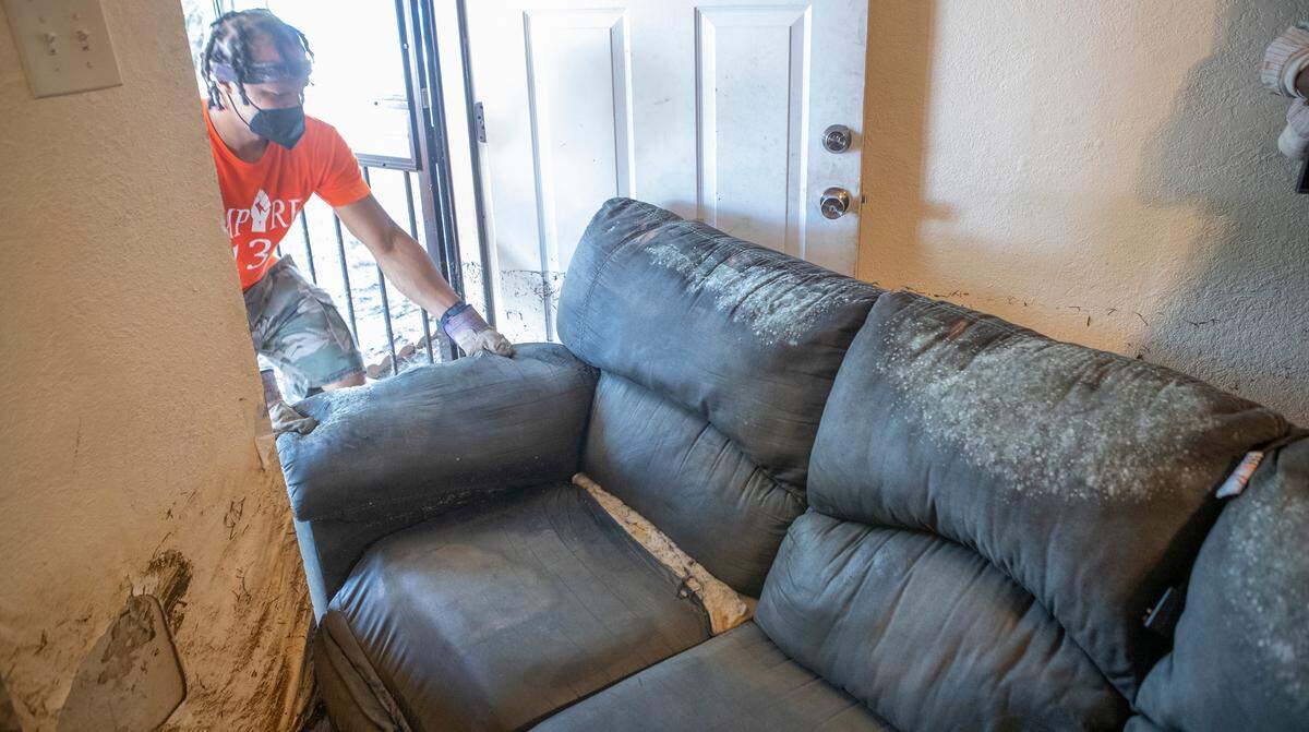 JD Dixon works to remove a moldy couch from an East St. Louis home that was saturated with flood water. A flood line can be seen on the door and walls showing that water was about 3 feet deep in the residence. The volunteers with Empire 13 and We Are The People STL removed furniture, carpet, and other items from East St. Louis homes in the Terrace Drive neighborhood that were flooded.