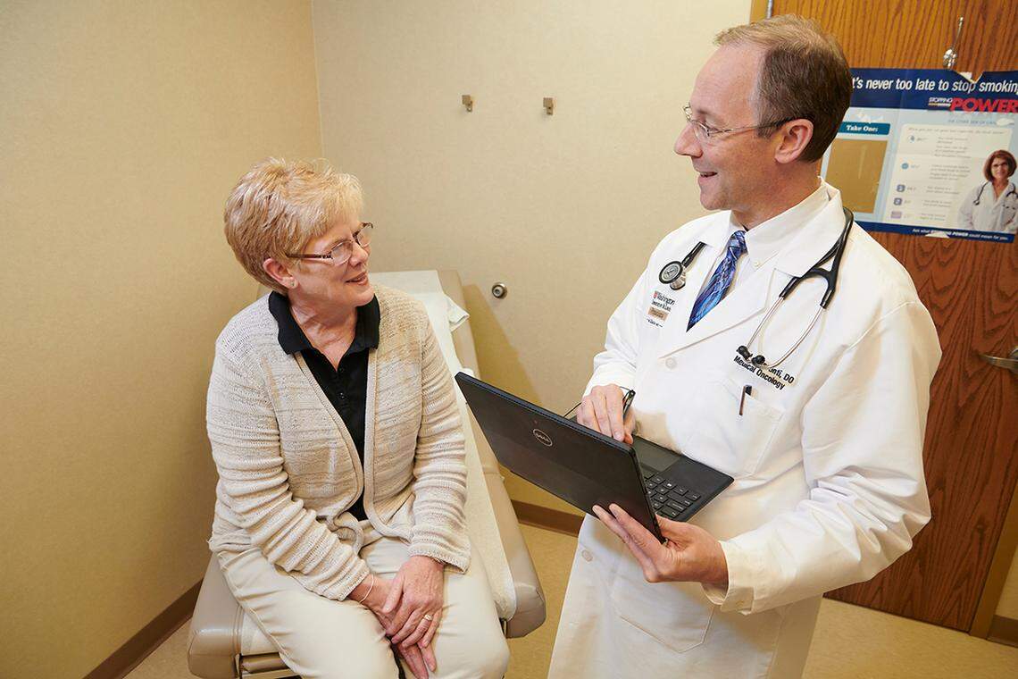 Patient Elizabeth Murphy consults with medical oncologist Dr. John L. Visconti at the new Siteman Cancer Center location in Swansea. Visconti formerly practiced with Oncology Ltd.