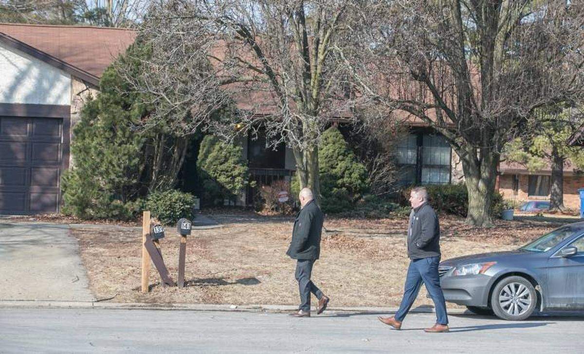 Investigators walk past 141 Paulette Drive in Belleville, where an accidental shooting killed 18-year-old Cole Wierciszewski on Feb. 12, 2018.