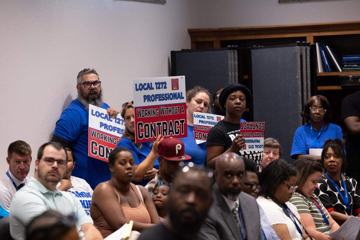 Members of Cahokia Federation of Teachers Local 1272 fill a schoolboard meeting to protest their grievances regarding their lack of a contract.