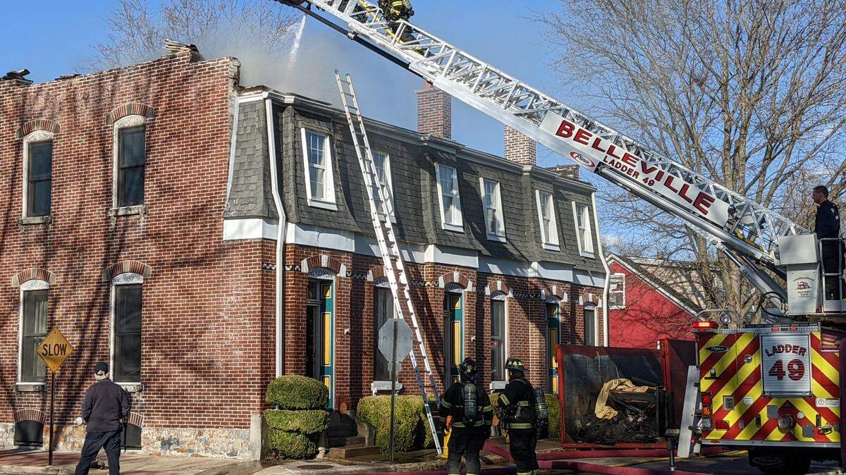 Belleville firefighters work to contain and put out the fire at 401 E. B St. on Friday