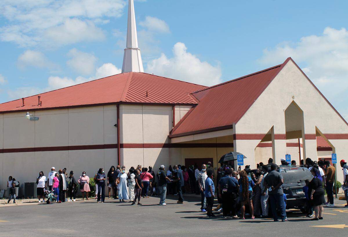 People begin to gather Aug. 21, 2021, outside Greater St. Mark’s Church of God in East St. Louis to attend the funeral for five young siblings who died in a fire at their home.