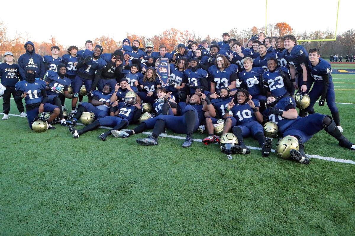 Althoff players celebrate their IHSA Class 1A semifinal victory over Camp Point Central Saturday. The Crusaders return to the state championship game at Hancock Stadium in Normal Friday.